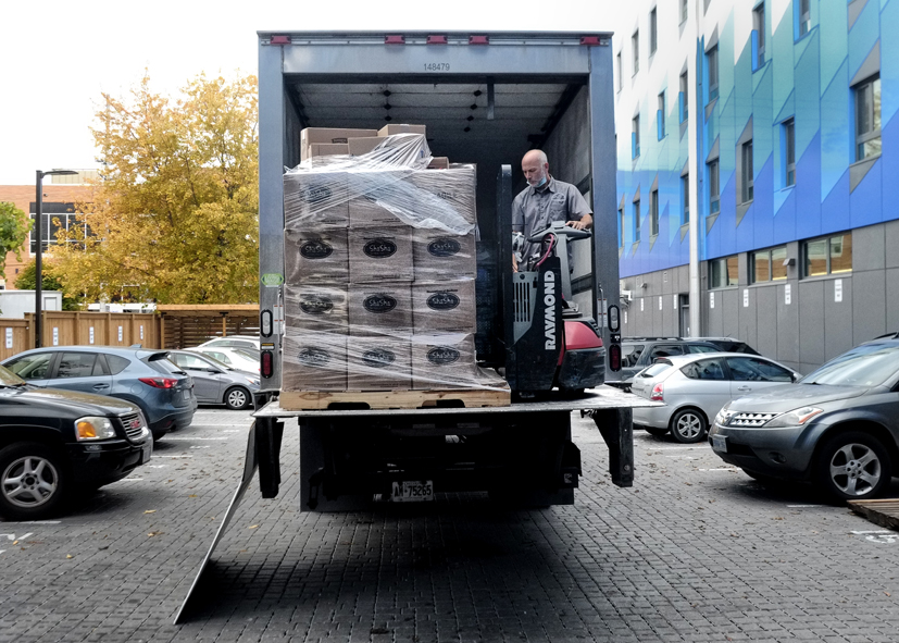 Truck unloading food at The Compass Food Bank & Outreach Centre