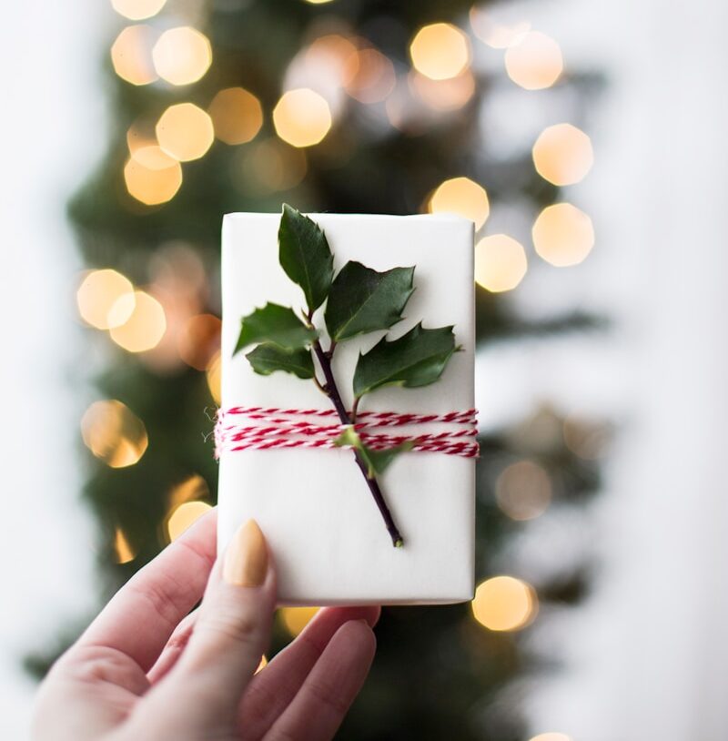 Christmas gift card in front of tree