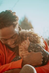 Person-holding-child-and-happy