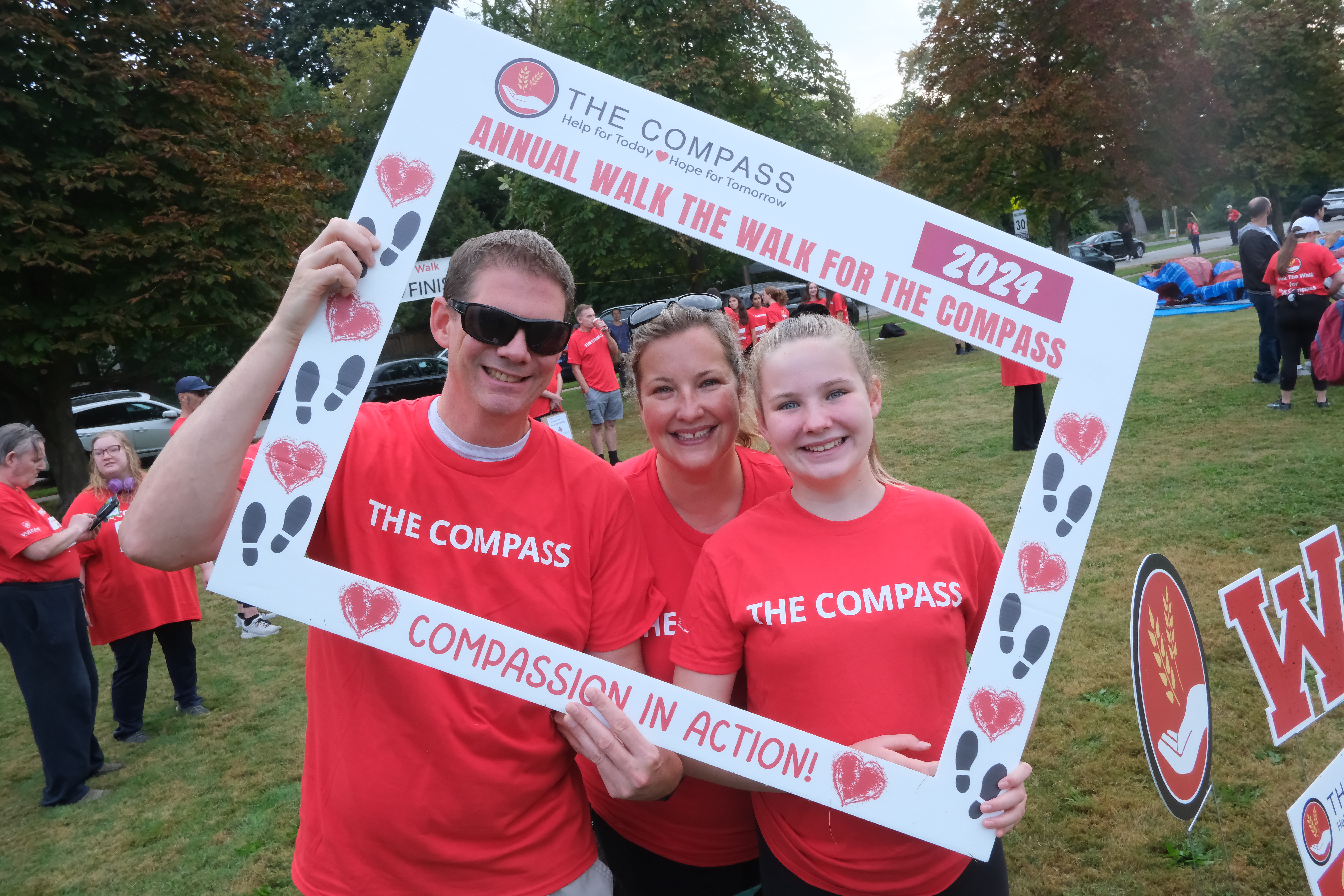 three-people-at-Compass-walk-holding-frame