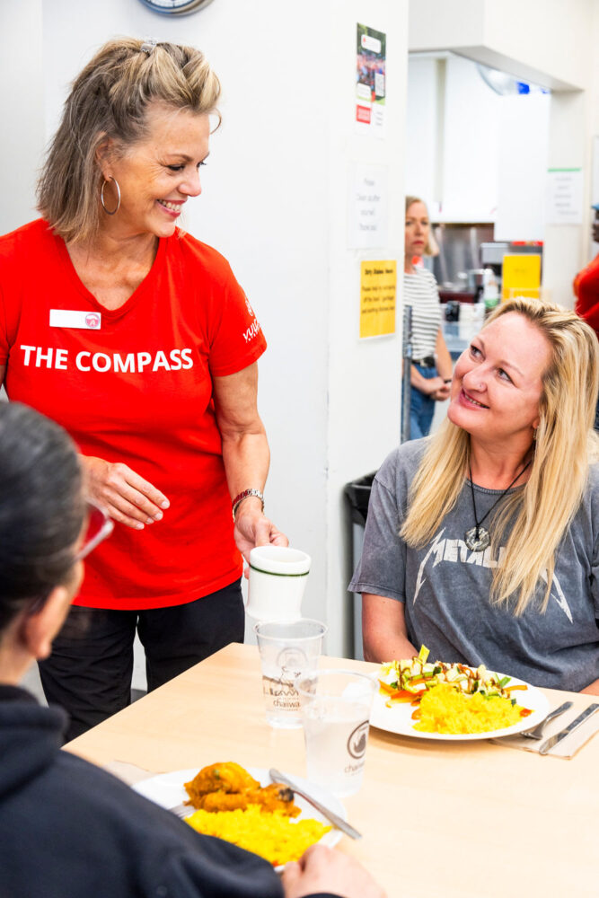 Volunteer serving coffee at The Compass community food bank in Mississauga